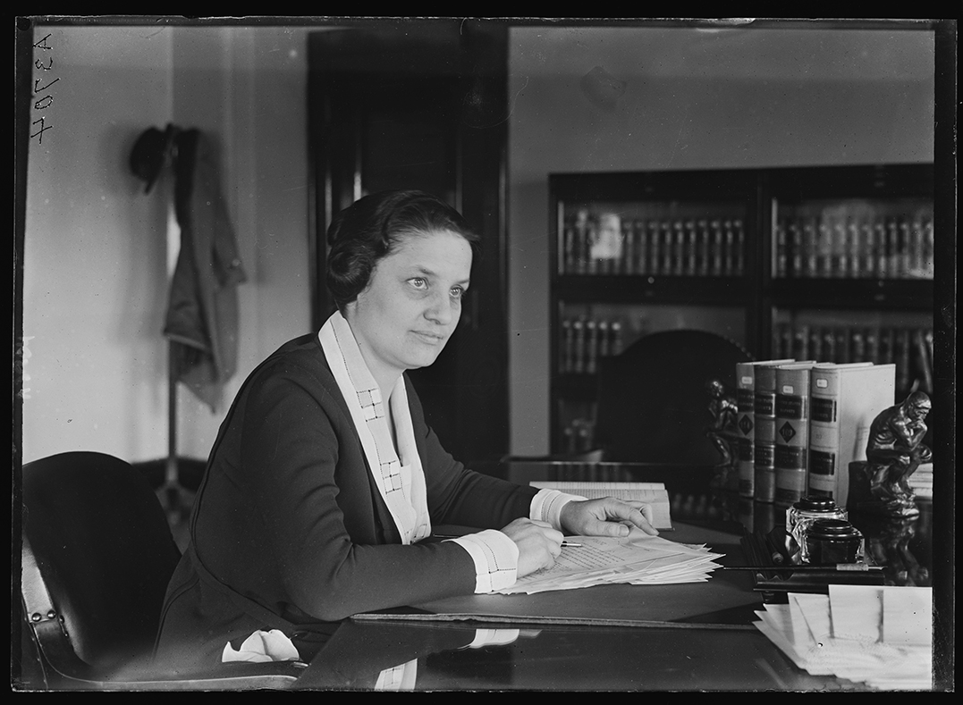 Willebrandt, Mabel at desk