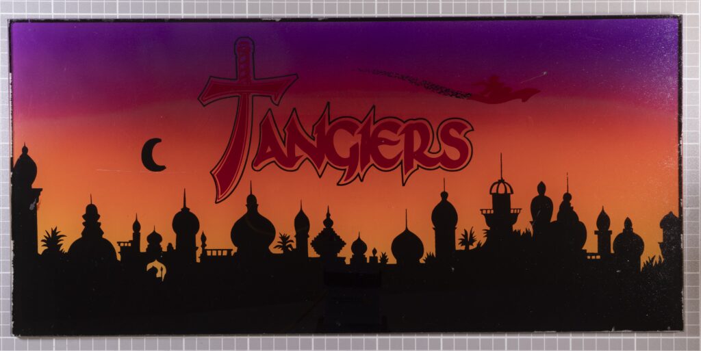 The fictional casino-resort Tangiers stood in for the Stardust. The interior casino scenes were filmed inside the Riveira, which was transformed into the Tangiers using props, including this slot machine faceplate. The Mob Museum Collection