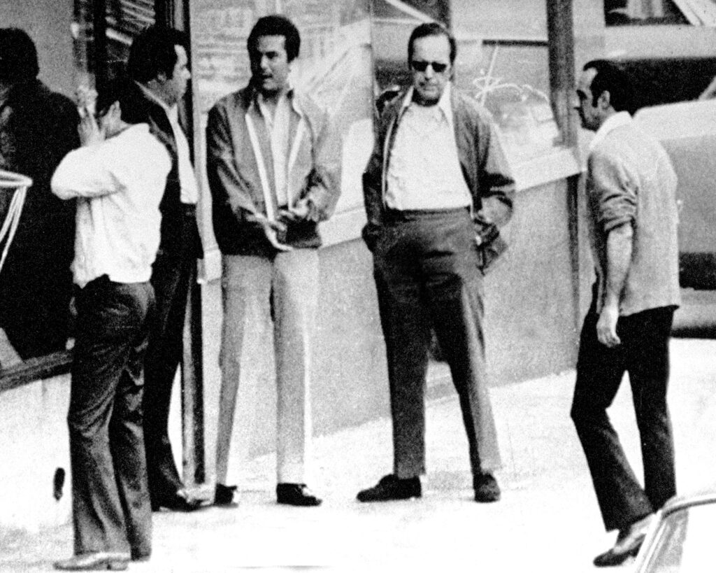 Angelo Ruggiero, second from left, speaks with John Gotti, middle, outside of the Bergin Hunt and Fish Club in 1986. Getty Images / New York Daily News Archive