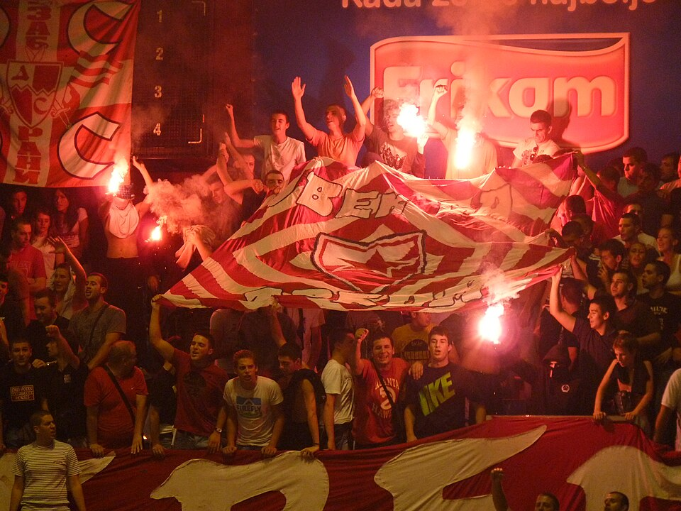 A group of Red Star Belgrade’s ultra fans, called Delije, cheers on their team during a soccer match. Some Delije have been tied to Serbian organized crime. Bobik at Serbian Wikipedia via CC BY 3.0 Serbia