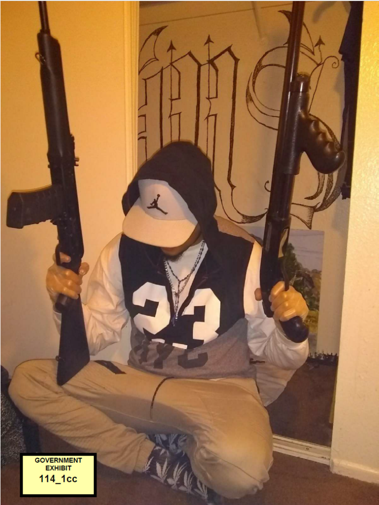 Reyes-Castillo poses with firearms in front of a makeshift MS-13 altar inside a closet. He is linked to nine of the 10 murders in the Las Vegas trial. U.S. Justice Department