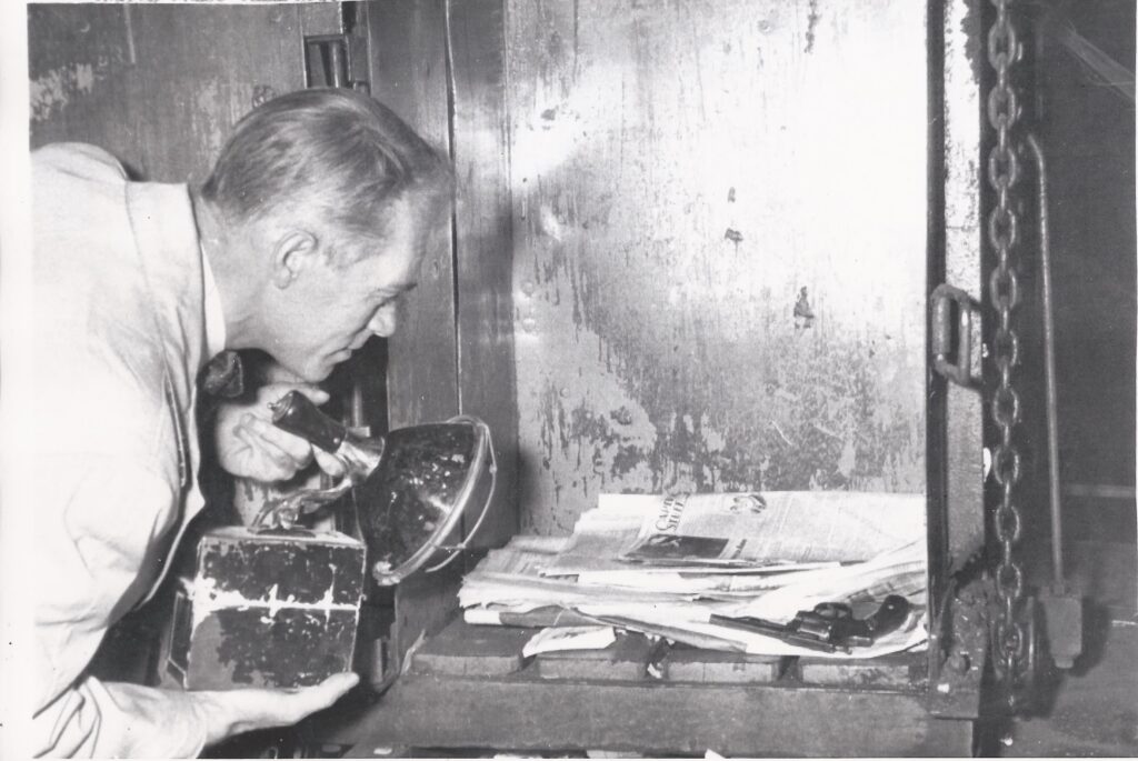 Investigators inspect a .32 caliber handgun found in a garbage bin used in the brazen hit on Albert Anastasia in 1957. Courtesy of Cipollini Collection